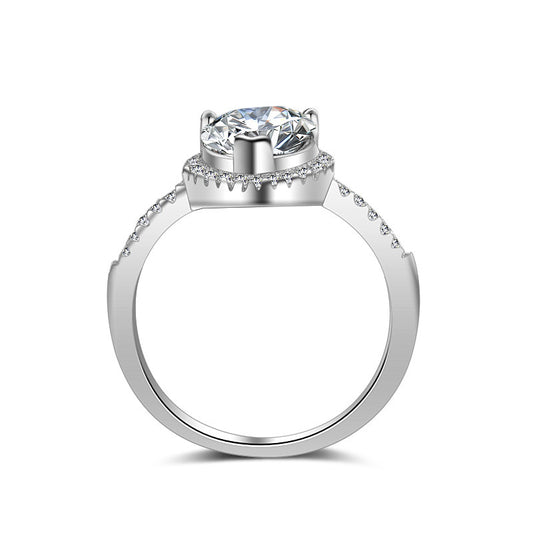 Diamond ring by cj featuring a solitaire center stone and pavé-band in silver-toned metal.