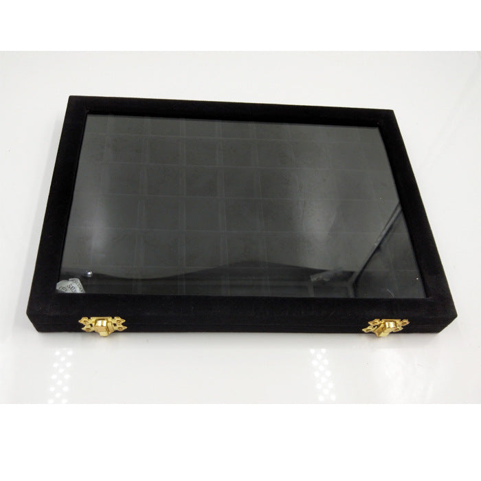 Jewelry display box with glass lid, black velvet exterior and gold clasps
