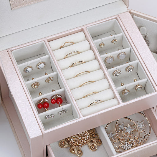 Pink double-layer PU leather jewelry box with cushioned ring and earring compartments, holds multiple pieces.