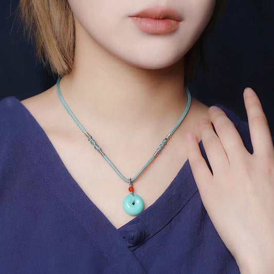 High Porcelain Turquoise Bread Ring Safety Buckle necklace with round turquoise pendant and red bead on a silver chain
