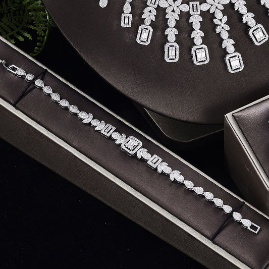 Zircon four-piece jewelry set: necklace, bracelet, ring and earrings in silver-tone with sparkling stones