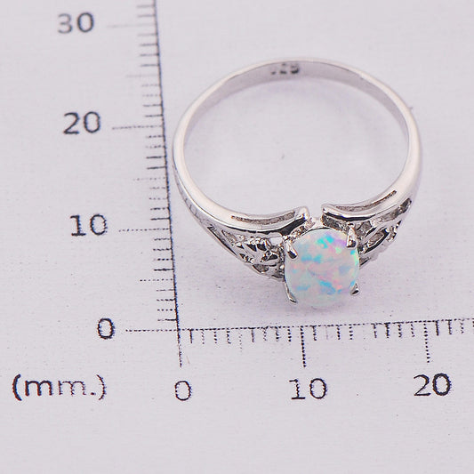 Ring CJ brand, silver-tone metal with oval multicolor opal centerpiece and side accents