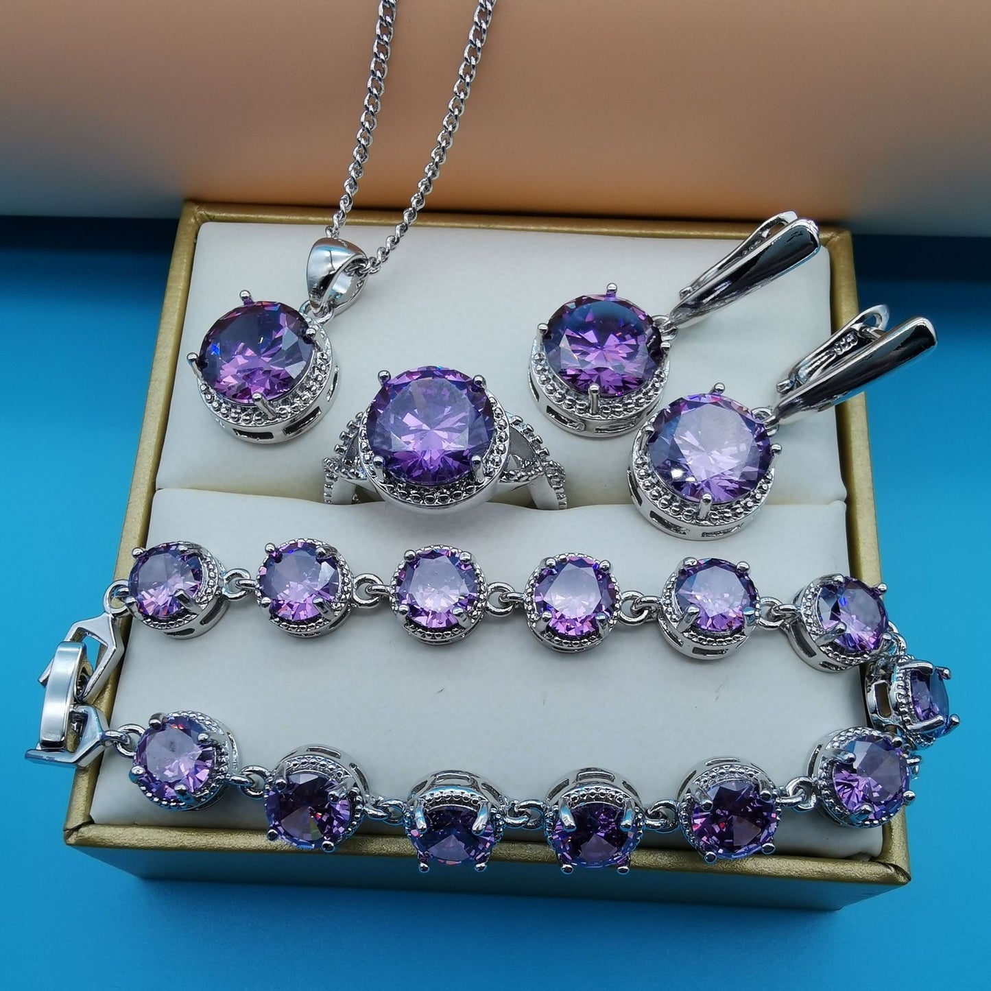 CJ 4-piece purple gemstone jewelry set with round-cut stones in silver-tone metal and halo accents.