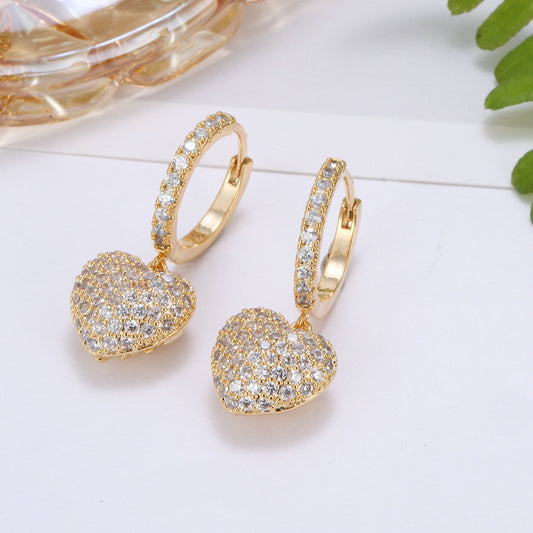Personalized wild copper zirconium diamond earrings, gold-tone hoop pair with pave heart pendants.