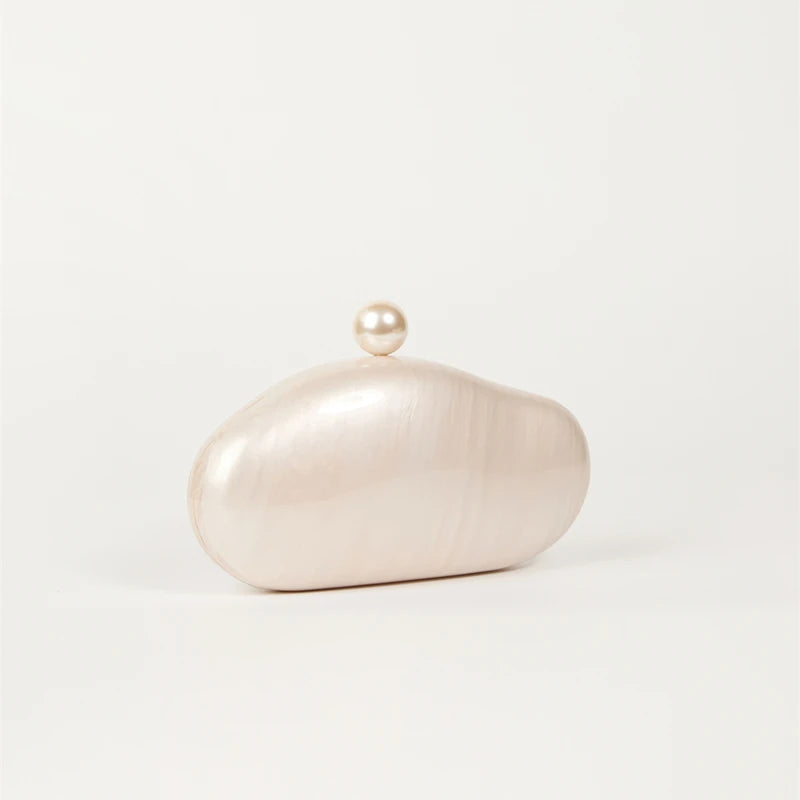 Shell clutch bag by Edenista in ivory acrylic pearl with pearl knob clasp