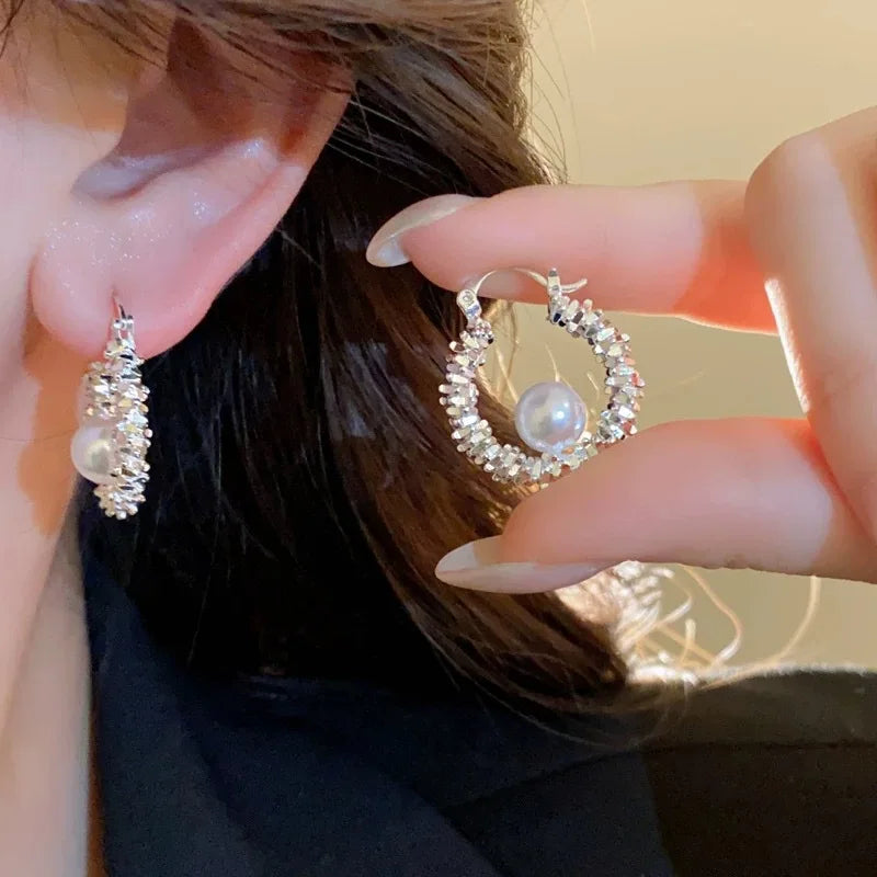 Pair of silver-tone hoop earrings with crystals and central imitation pearls