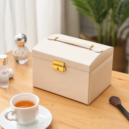 edenista cream three-layer drawer jewelry storage box with gold latch and top handle on a wooden table