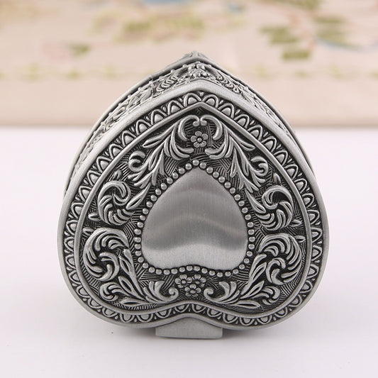 Heart-shaped jewelry storage box with ornate silver-tone engraving for brooches and rings, antique finish