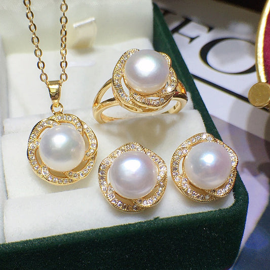 Freshwater pearl jewelry set in gold-tone with pave crystal halos; necklace pendant and three rings