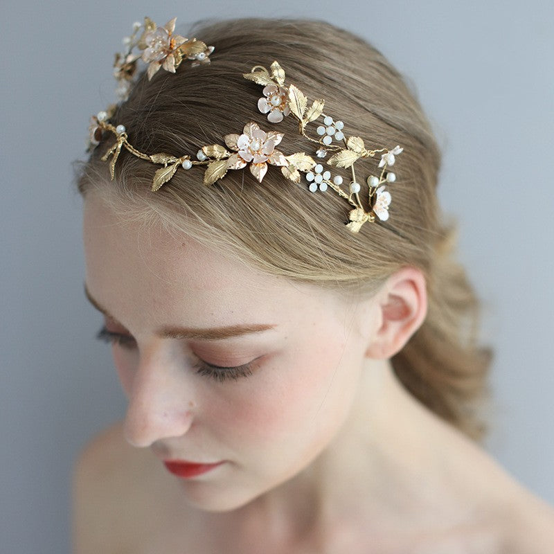Elegant gold floral headpiece with pearl accents, bridal hair accessory for romantic updos.