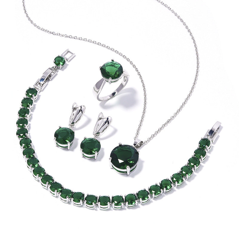 Geometric round emerald-green jewelry set, 4-piece silver-tone with emerald stones: necklace, bracelet, ring, earrings.