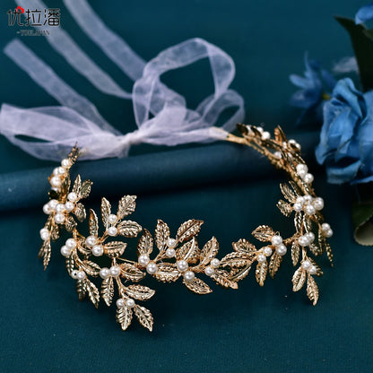 Bridal headband alloy with gold-tone leaf motif and pearl beads on a sheer ribbon.