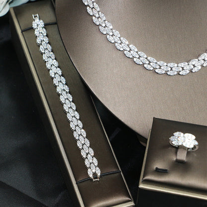Bridal zircon four-piece jewelry set with silver-tone necklace, bracelet, and ring