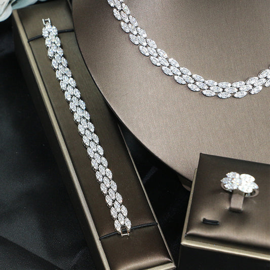 Bridal zircon four-piece jewelry set with silver-tone necklace, bracelet, and ring