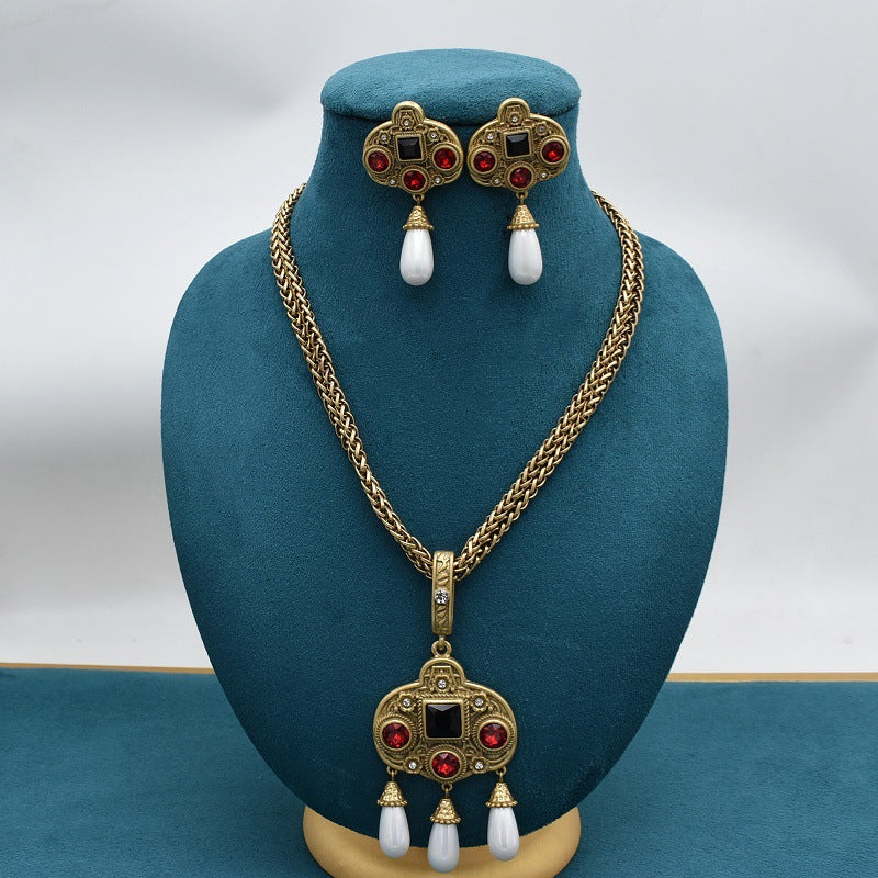 Vintage glass-inlaid tassel pearl necklace and earrings set; gold-tone with red stones and white pearl drops