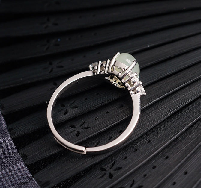 Adjustable moonstone jade ring in 925 silver by CJ, pale green gemstone centerpiece.