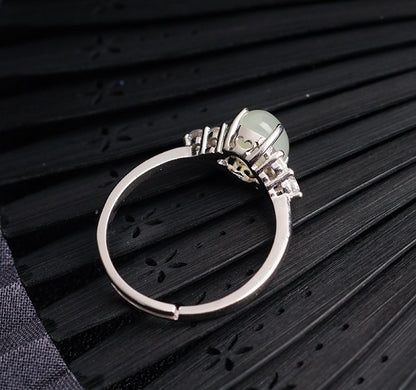 Adjustable moonstone jade ring in 925 silver by CJ, pale green gemstone centerpiece.
