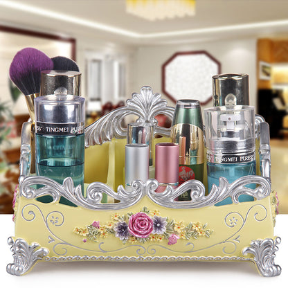 Desktop jewelry box by edenista; ornate yellow base with silver scrollwork and rose accents, holding makeup bottles