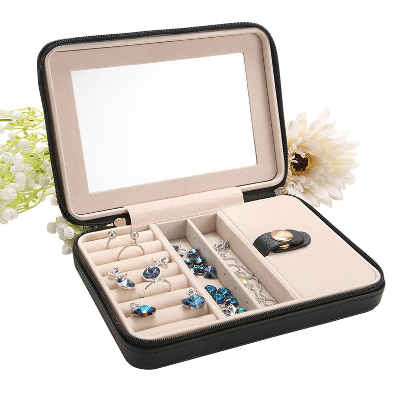 Jewelry box portable black by Edenista with beige interior and multiple compartments, mirror inside lid, jewelry pieces