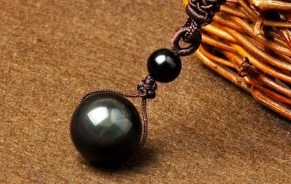 Obsidian rainbow-eye pendant necklace with a large black pearl on a brown polyester rope chain