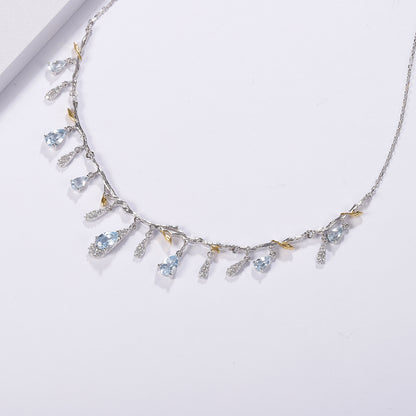S925 silver natural topaz necklace with blue teardrop gems, crystal charms, and gold-tone leaf accents on a branch chain