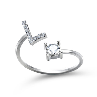 Adjustable silver-tone L-shaped initial-letter ring with pavé diamonds and a solitaire center stone