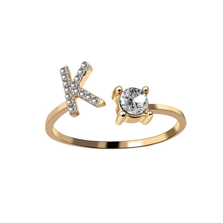 gold-tone adjustable ring featuring a pavé-crystal X and a solitaire gemstone setting