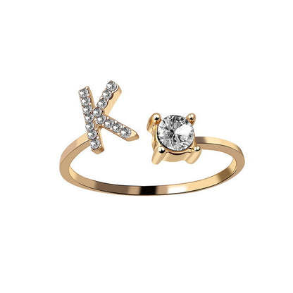 gold-tone adjustable ring featuring a pavé-crystal X and a solitaire gemstone setting