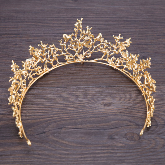 Bridal crown headband in gold-tone floral filigree, wedding dress accessory with intricate branch design.