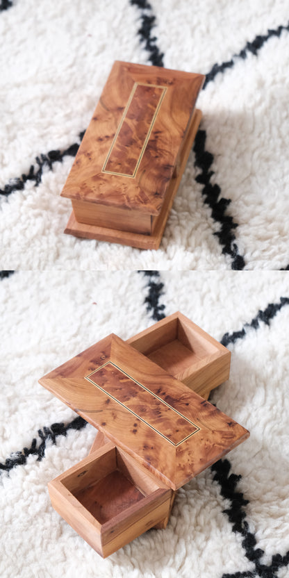 Moroccan handmade rotating wooden jewelry box in burl wood with a gold bordered lid.