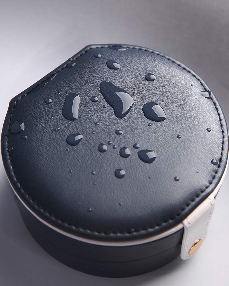 edenista portable jewelry box, round navy blue leather case with white strap and water droplets
