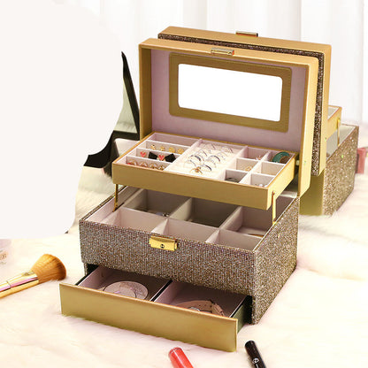 Edenista jewelry box organizer with gold glitter exterior, pink lining, and multi-tier compartments