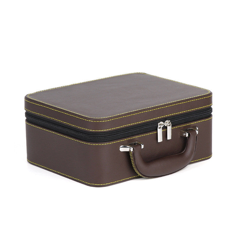 Brown leather travel jewelry box with double layer, yellow stitching, zip closure, and a carrying handle.