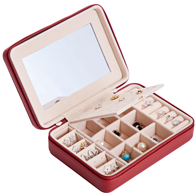Multifunctional jewelry storage box in red with beige interior and built-in mirror, organized for earrings and rings