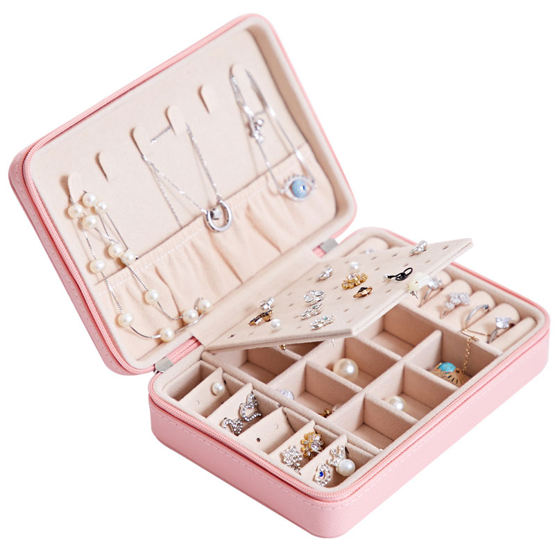Pink multifunctional jewelry storage box opened with compartments for earrings and rings