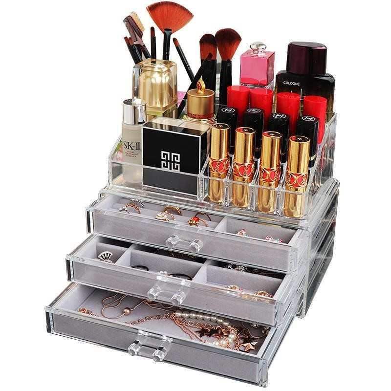 Acrylic jewelry storage box by edenista with clear drawers and a top makeup organizer for lipstick and brushes.