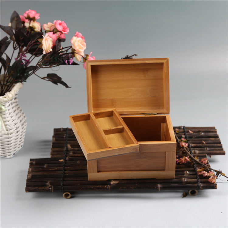 Bamboo wooden jewelry box with lid open and divided interior compartments