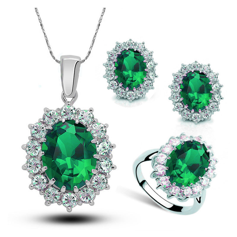 Crystal Jewelry bridal 3-piece set: necklace, earrings, and ring with emerald-green center stones surrounded by clear crystals