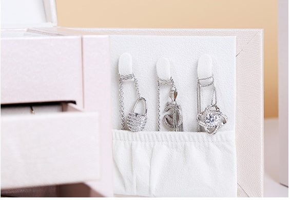 edenista PU leather jewelry box in pale pink, double-layer storage with 3 hanging necklaces visible