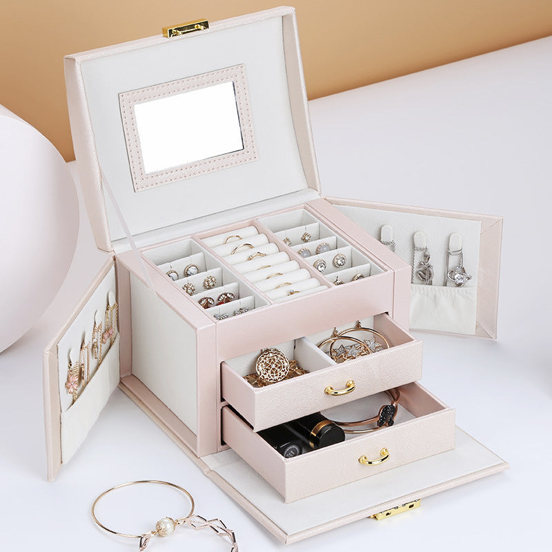 Double-layer pink PU leather jewelry box by Edenista with large capacity compartments and pull-out drawers.