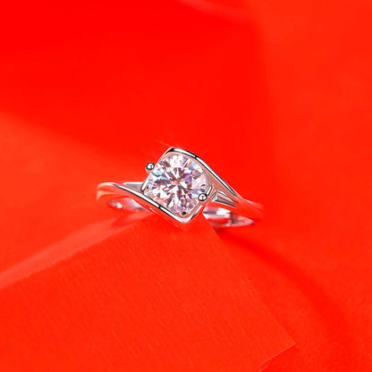 Women’s moissanite imitation diamond ring in silver-tone metal with round centerpiece.