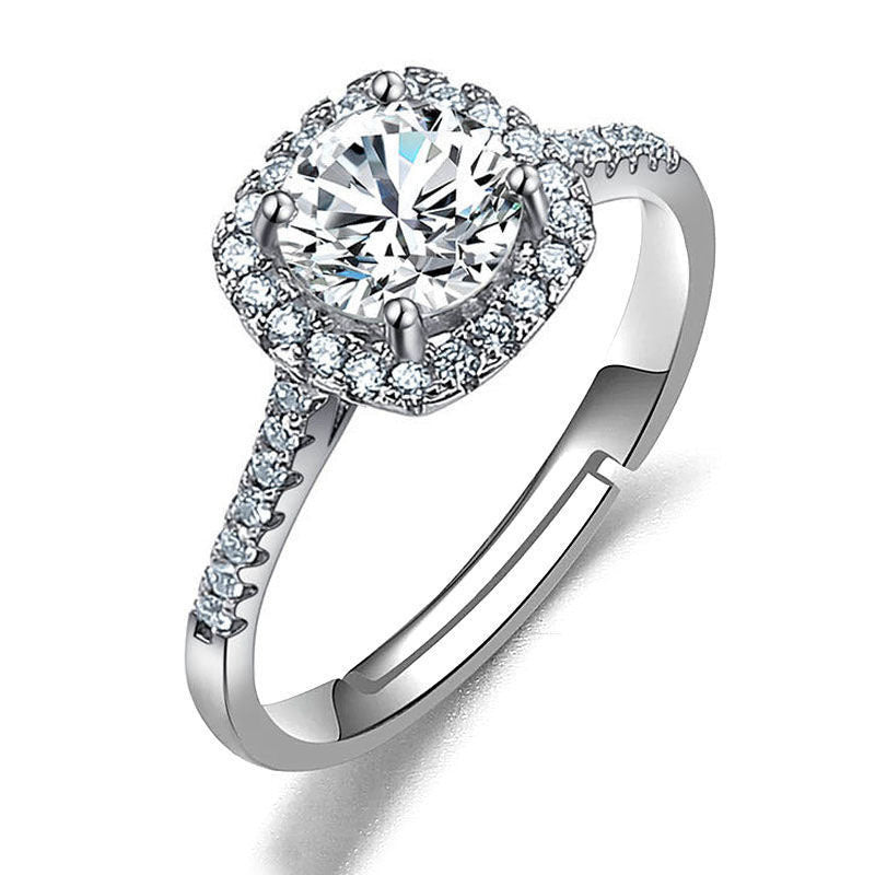 Women's imitation moissanite halo ring with pave band on silver-tone metal.