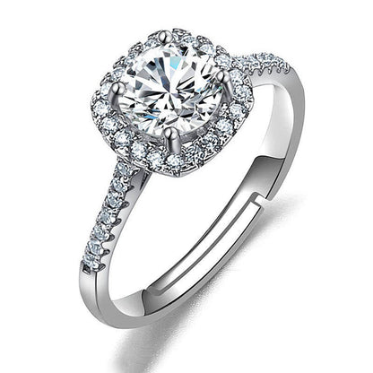 Women's imitation moissanite halo ring with pave band on silver-tone metal.