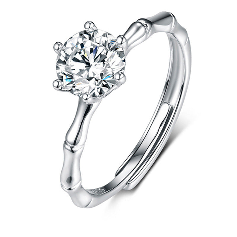 Women's moissanite ring by CJ with a round-cut clear stone on a polished silver band