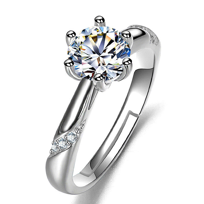 Moissan diamond ring for women with a six-prong solitaire center stone and pavé diamonds along the silver band