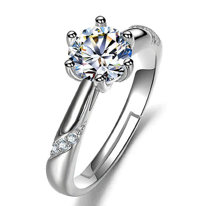 Moissan diamond ring for women with a six-prong solitaire center stone and pavé diamonds along the silver band