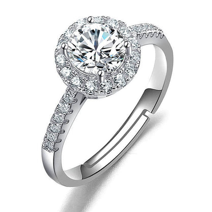 Ring in silver-tone metal with center moissanite halo and pave band