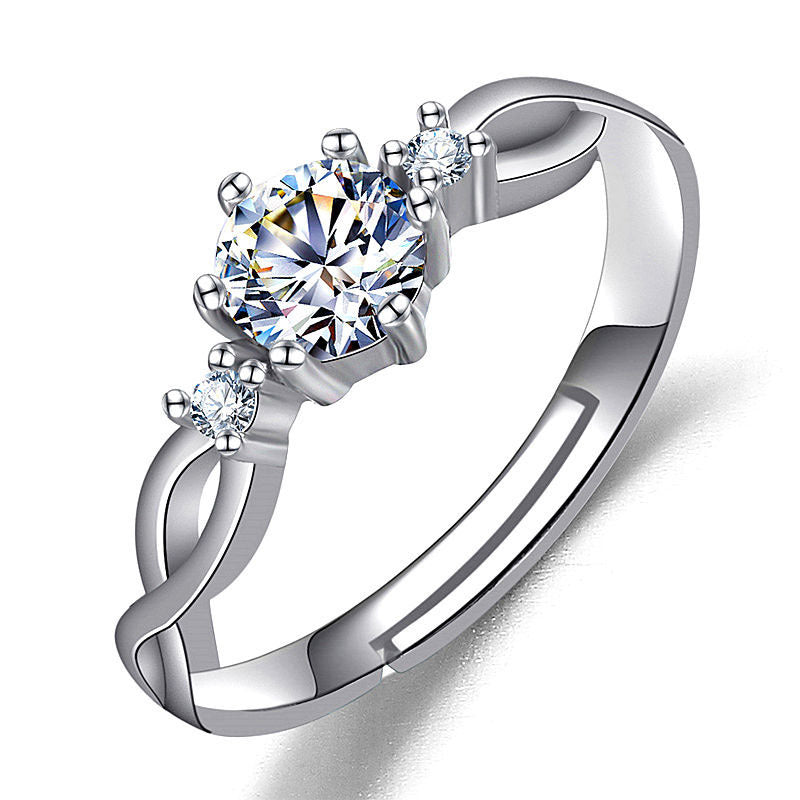 Women’s silver ring with a large imitation moissan diamond and two side stones.