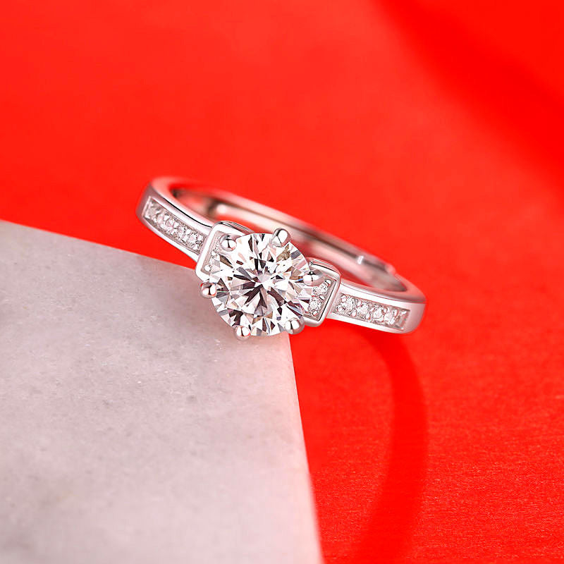 Women's silver ring with round moissanite center stone and pavé side stones by cj