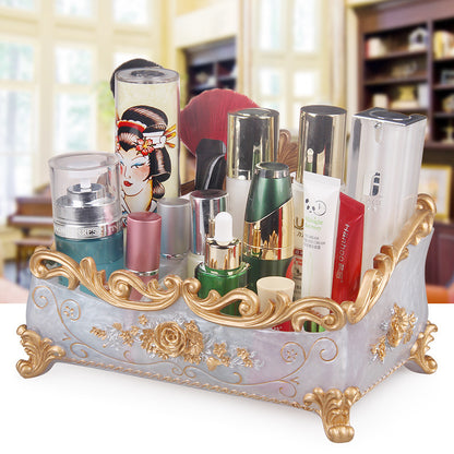 Desktop jewelry box by edenista, with ornate gold-tone filigree and ivory base, filled with cosmetics and accessories